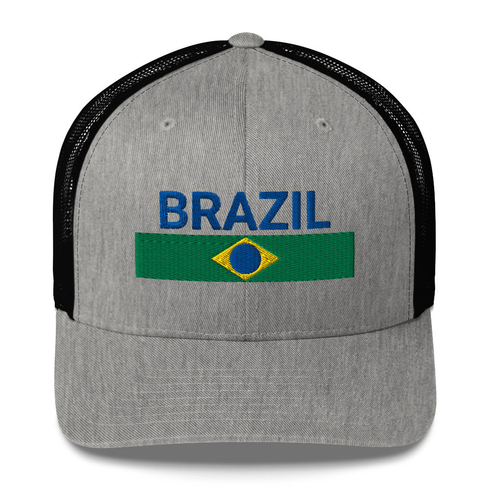 Gorra trucker con texto bordado “Ordem e Progresso” en verde, amarillo y azul sobre fondo beige.