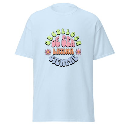 Retro groovy t-shirt design featuring "ORGULLOSA DE SER LATINA SIEMPRE" in curved bubble letters - lime green for "ORGULLOSA", soft pink for "DE SER", coral orange for "LATINA", and sky blue for "SIEMPRE", decorated with pink daisy flowers with yellow centers on both sides
