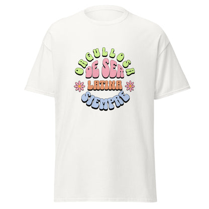 Retro groovy t-shirt design featuring "ORGULLOSA DE SER LATINA SIEMPRE" in curved bubble letters - lime green for "ORGULLOSA", soft pink for "DE SER", coral orange for "LATINA", and sky blue for "SIEMPRE", decorated with pink daisy flowers with yellow centers on both sides